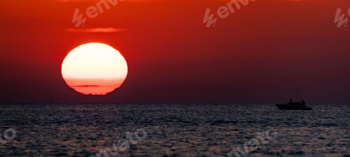 Preview: Beautiful shot of a boat in the sea in the sunset