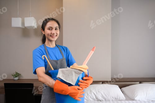 Preview: Professional cleaner woman in rubber gloves holding bucket with fabric clothes and brush to clean