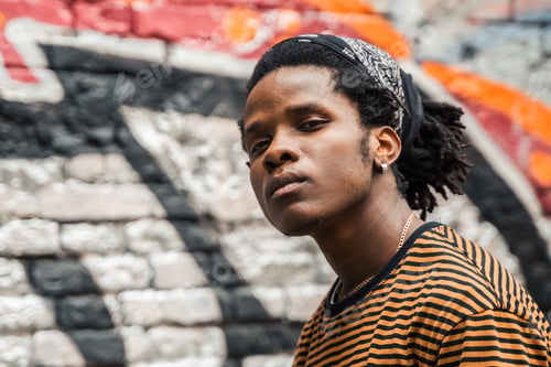 Preview: Portrait of young handsome stylish black man with natural hair afro dreadlocks. Afroamerican guy. St