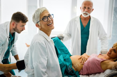 Preview: Woman giving birth in hospital with medical doctor team