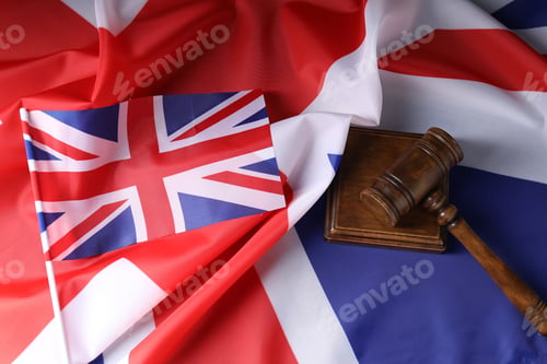Preview: Judge's gavel on flags of United Kingdom, top view
