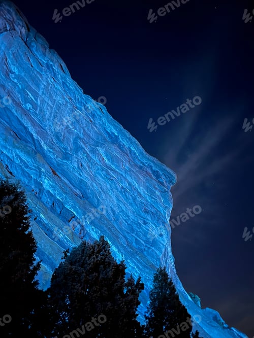 Preview: Red rocks lit up by a blue light at night during a concert at Red Rocks Amphitheater