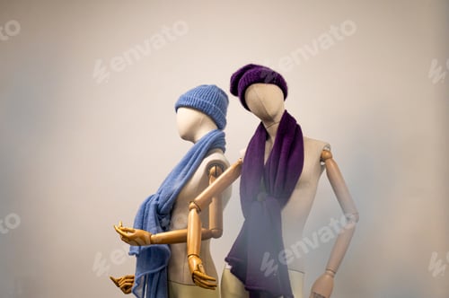Preview: boutique with females fashion, mannequins with winter hats and scarves