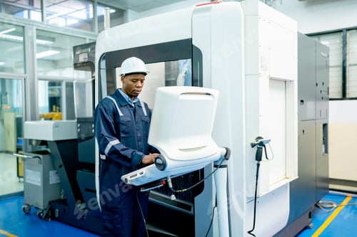 Preview: African American worker do some works with keyboard and monitor of controlling part of factory robot