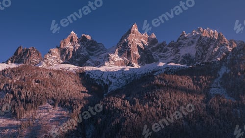 Preview: the snowy mountains are covered with trees and snowboarders