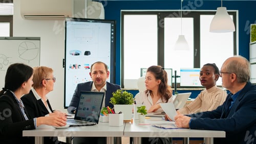Preview: Multiethnical team talking with remote manager during virtual meeting