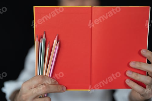 Preview: Red background in the book and the pencils
