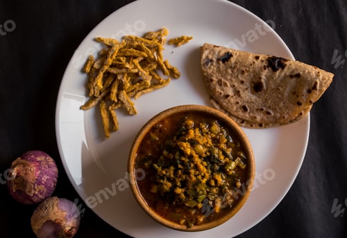 Preview: Top view of Indian vegetarian lentil soup served with paratha flatbread