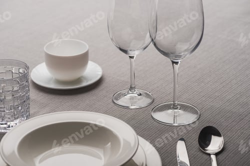Preview: Clear Wine Glasses Beside Dishware And Coffee Cup on Grey Cloth
