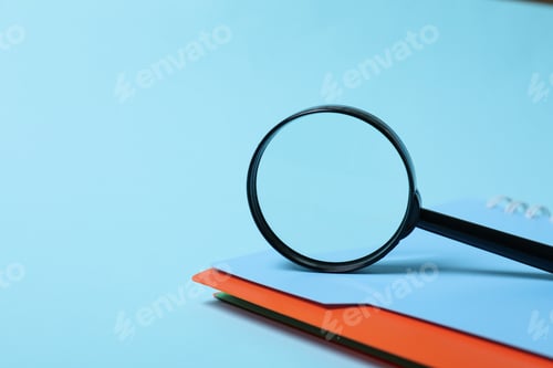 Preview: Magnifying glass and notepad on blue background, space for text