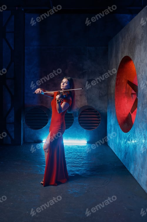 Preview: Female violinist performing on grange stage for camera