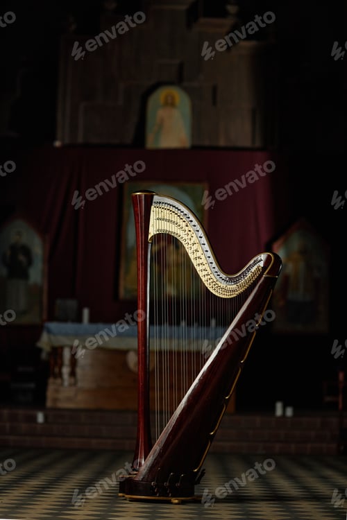 Preview: Professional Antique Harp Captured in Dimly Lit Church