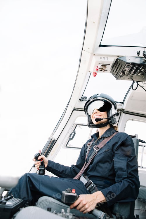 Preview: Attractive woman pilot sitting in the helicopter
