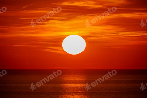Preview: Fantastic sunset over ocean. The sun goes down over the sea. Dramatic Sunset Sky