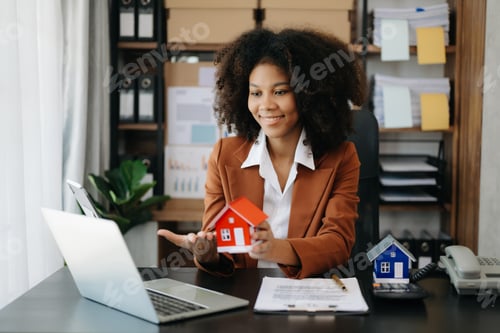 Preview: Young real estate agent worker working with laptop and tablet at table in office and small