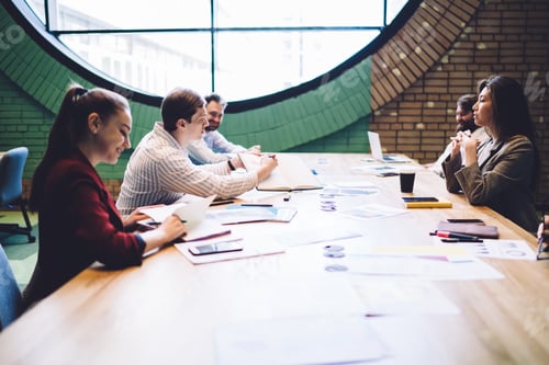 Preview: Executives sitting at meeting table in company