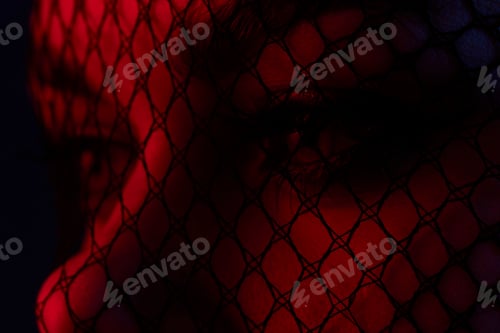 Preview: attractive woman black veil on the face close-up red light color background