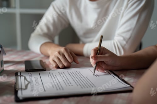 Preview: Professional Real Estate Agent Assisting Client with Property Contract Signing in Modern Office