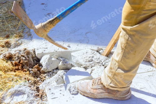 Preview: Construction site worker smashes concrete driveway with pickaxe
