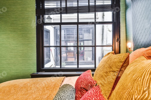 Preview: Bed with colorful pillows near window