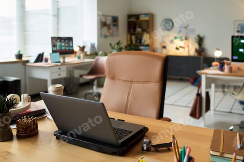 Preview: Modern Office Workspace Featuring Laptop Computer on Desk in Daylight