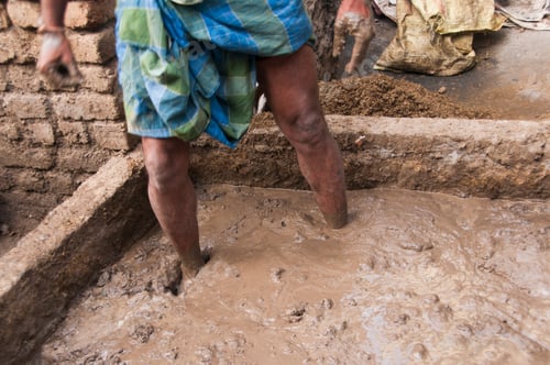 Preview: Potter preparing clay for making pots, India.