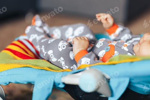 Preview: nice blue eyed Baby child relaxing on a sunbed or a deck chair colored bouncer at home