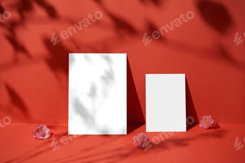 Preview: Blank paper sheet card with copy space and sunlight shadow on red background.