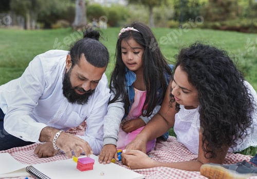 Preview: Happy indian family having playful time at park - Concept of family love