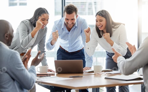 Preview: Shot of a group of businesspeople cheering while using a laptop in an office at work