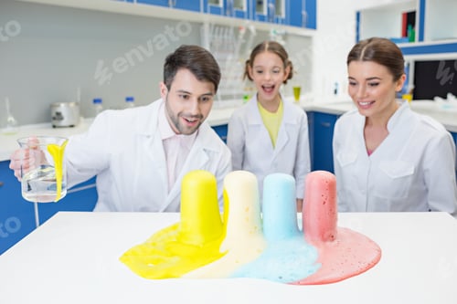 Preview: portrait of cheerful teachers and girl student scientists making experiment in lab