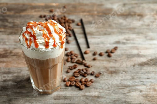 Preview: Glass of coffee with caramel topping on wooden background