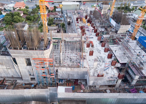 Preview: Aerial view of busy industrial construction site workers working. Development high rise building.