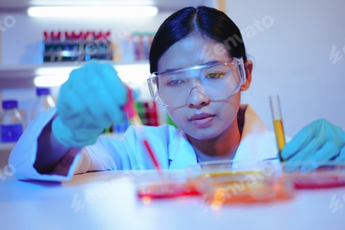 Preview: Asian female scientist passionately conducts experiments in a laboratory