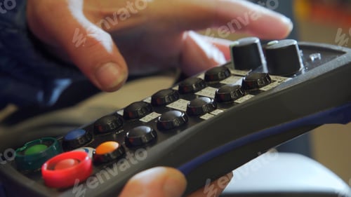 Preview: Black control panel. Creative. A special control panel in strong male hands.