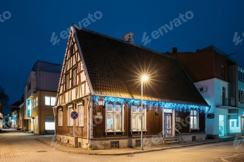 Preview: Parnu, Estonia. Night View Of Old Wooden Parnu Citizen’s House At Nikolai Street In Evening Night