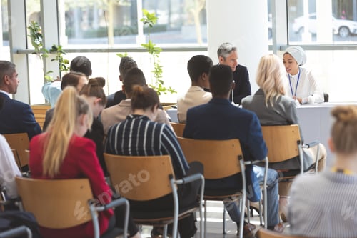Preview: Group of business people attending business seminar in office building