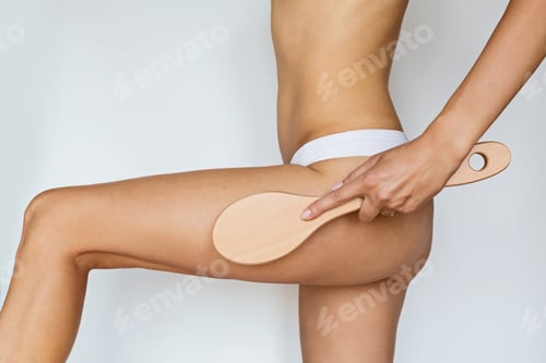 Preview: Woman using brush on skin, dry anti cellulite massage isolated on white background, beauty care