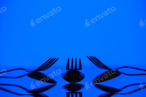 Preview: front view metal forks on blue background cutlery kitchen food color photo table dinner restaurant