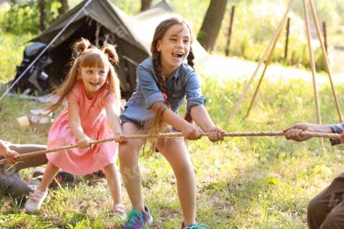 Preview: Little children pulling rope outdoors. Summer camp