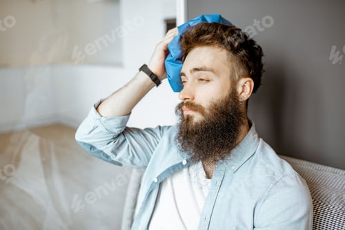 Preview: Man with headache at home