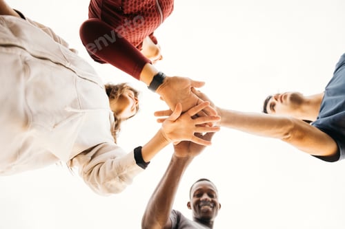 Preview: Group of diverse friends joining hands in unity
