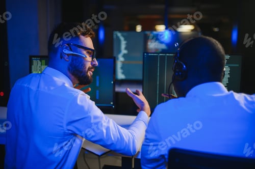 Preview: Diverse call center operators team use computers consulting clients in office