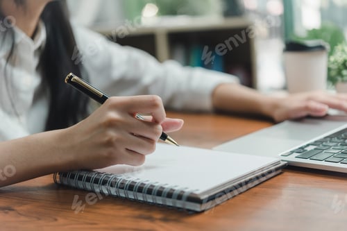 Preview: Woman hand with notebook for planning with laptop