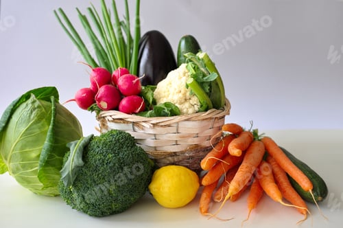 Preview: Healthy vegetables in wicker basket on white table