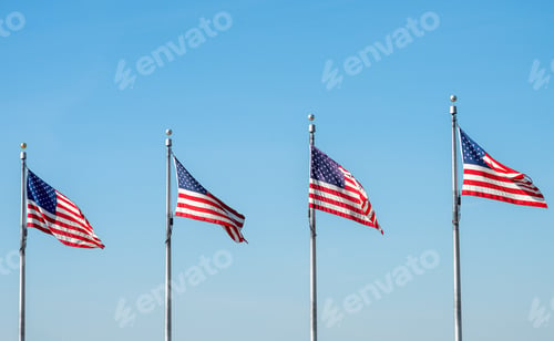 Preview: Four US flags waving in the wind