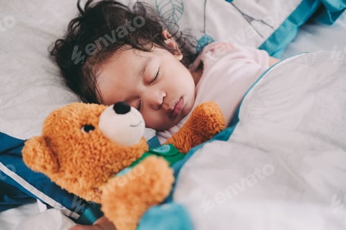 Preview: Baby girl at home sleeping with favorite stuffed animal a teddy bear