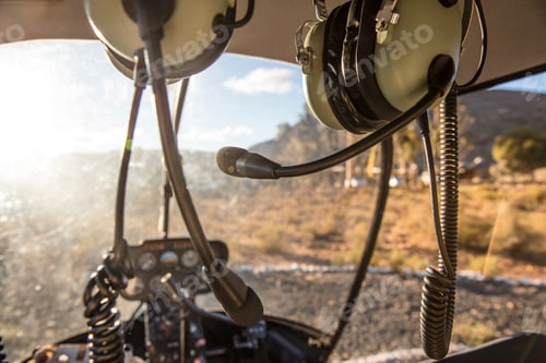 Preview: Helicopter cockpit with headphones and sunny landscape view