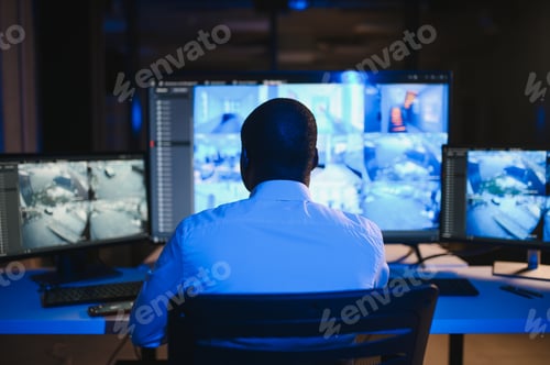 Preview: African American security operator use computer with screens showing surveillance camera footage