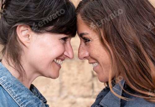 Preview: close-up of a young lesbian couple looking into each other's eyes, homosexual concept
